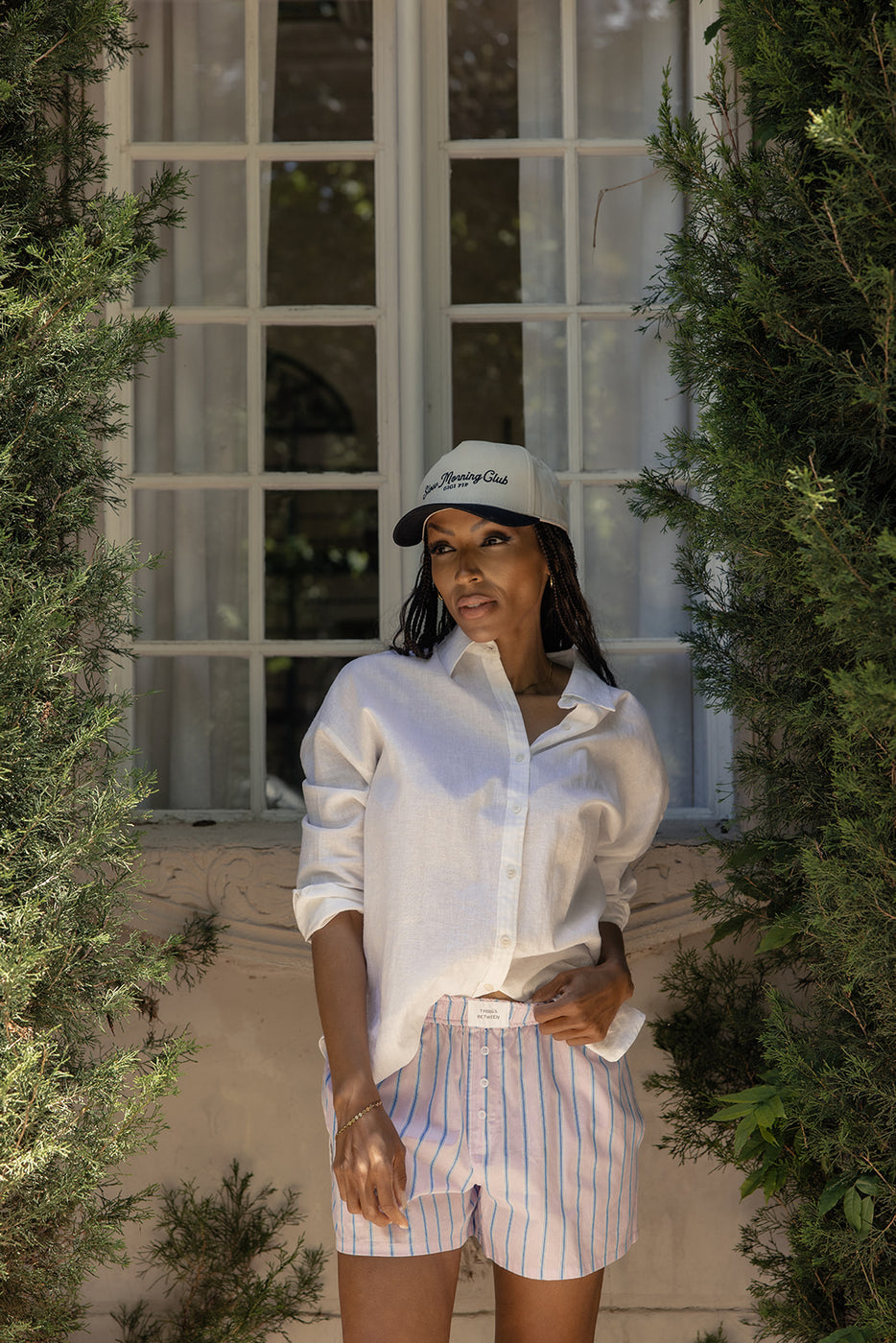 a woman in a white shirt and striped pants