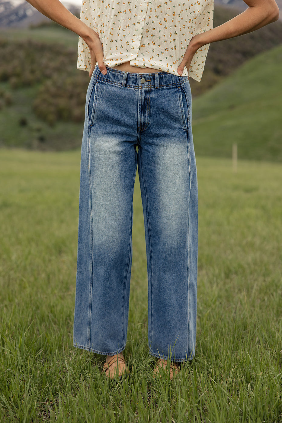 a person wearing jeans in a field