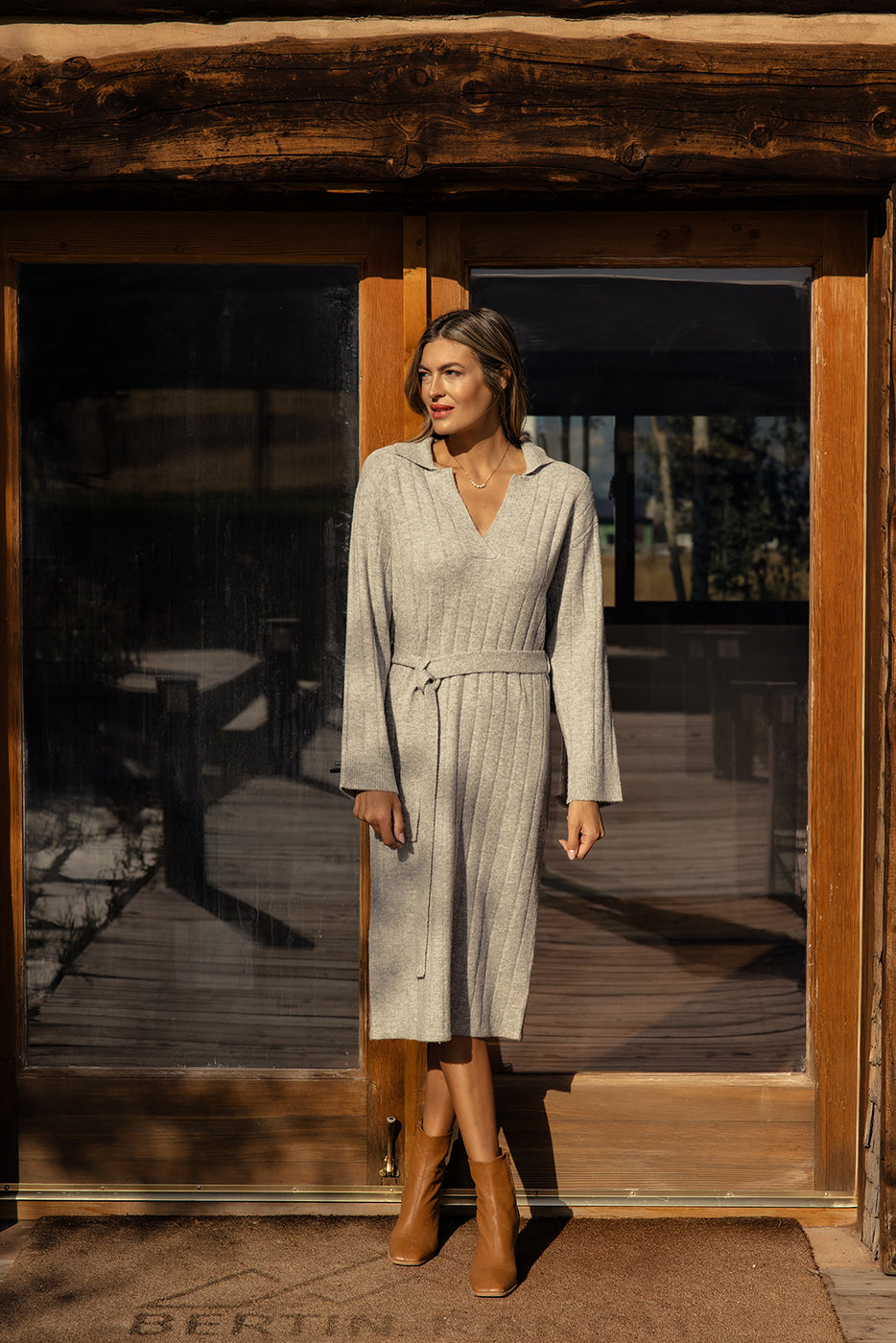 a woman standing in front of a door