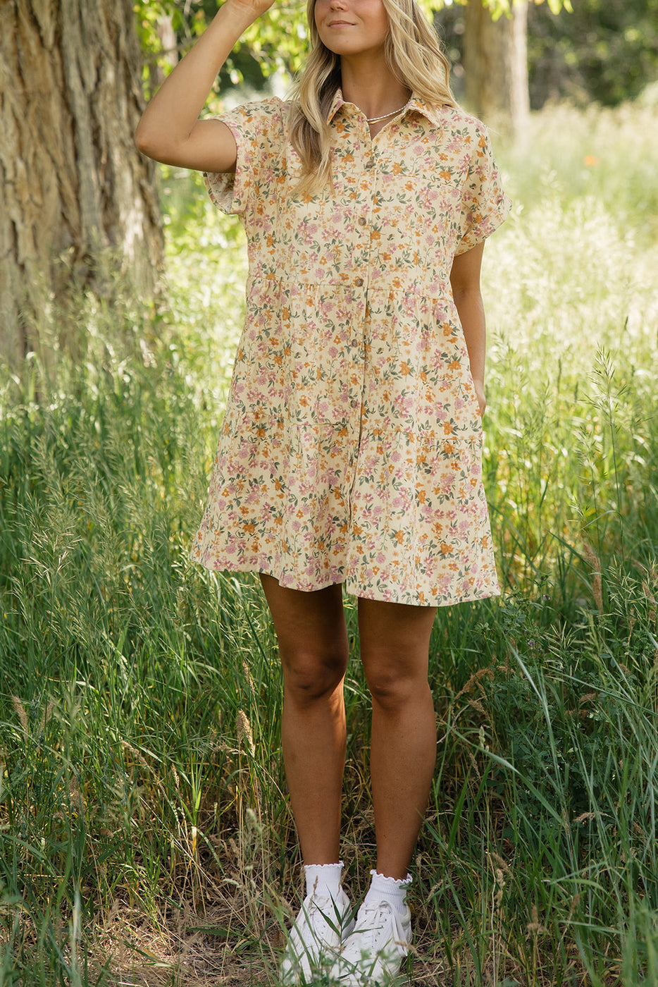 a woman standing in tall grass