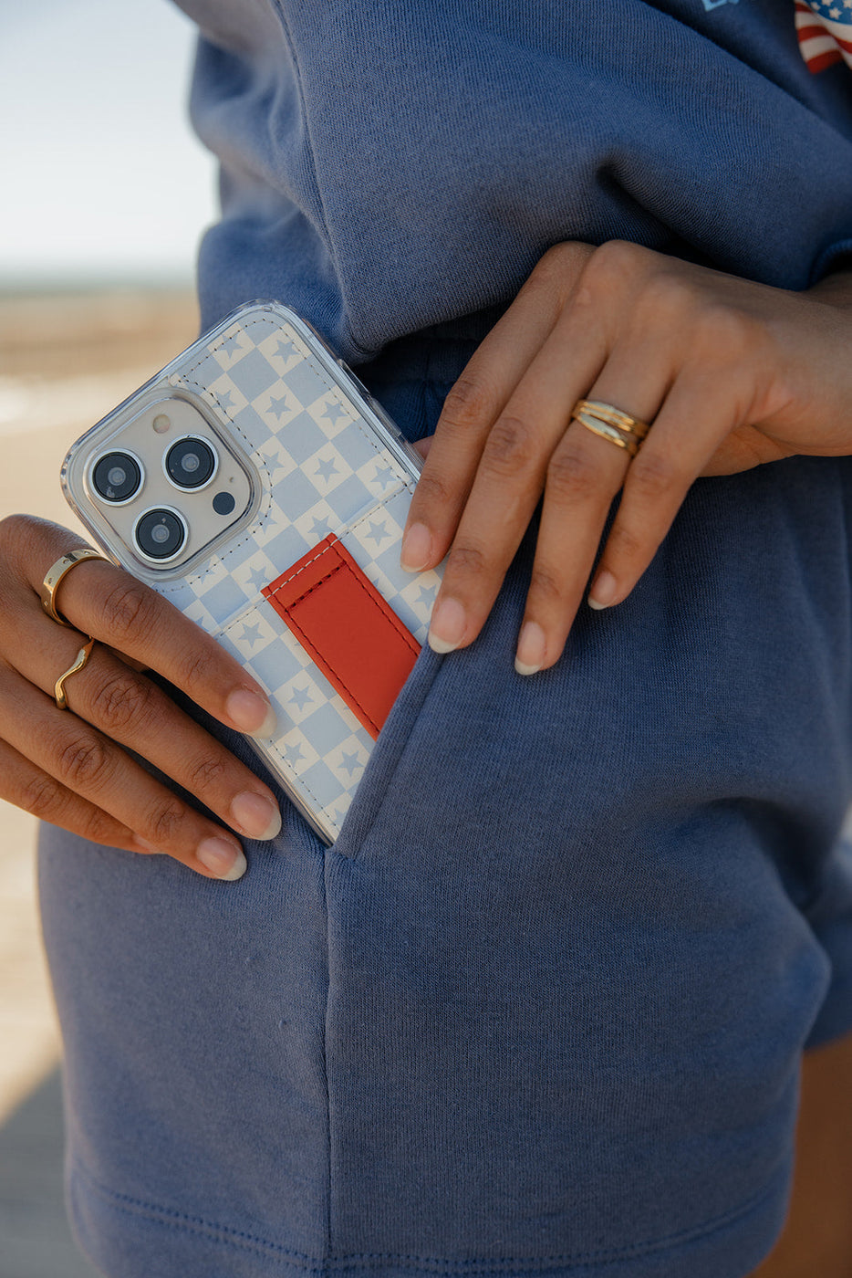 a person holding a phone in their pocket