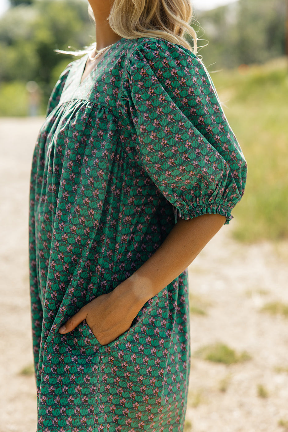 a woman wearing a green dress