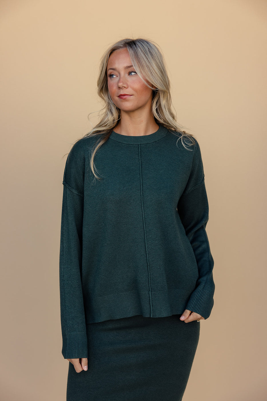 a woman in a green sweater