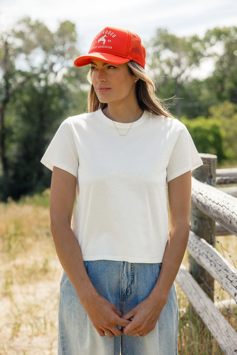 a woman wearing a white shirt and blue jeans