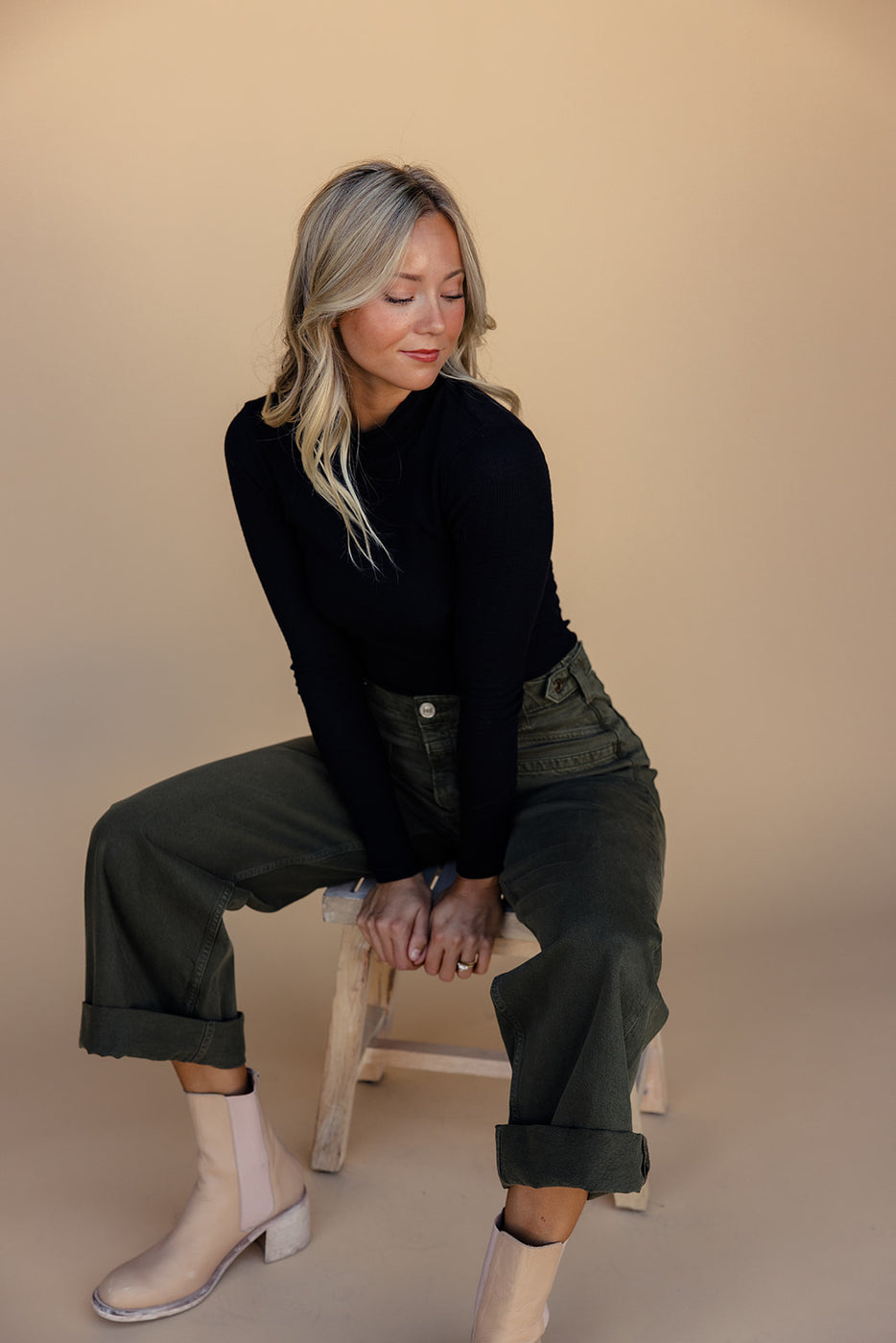 a woman sitting on a stool