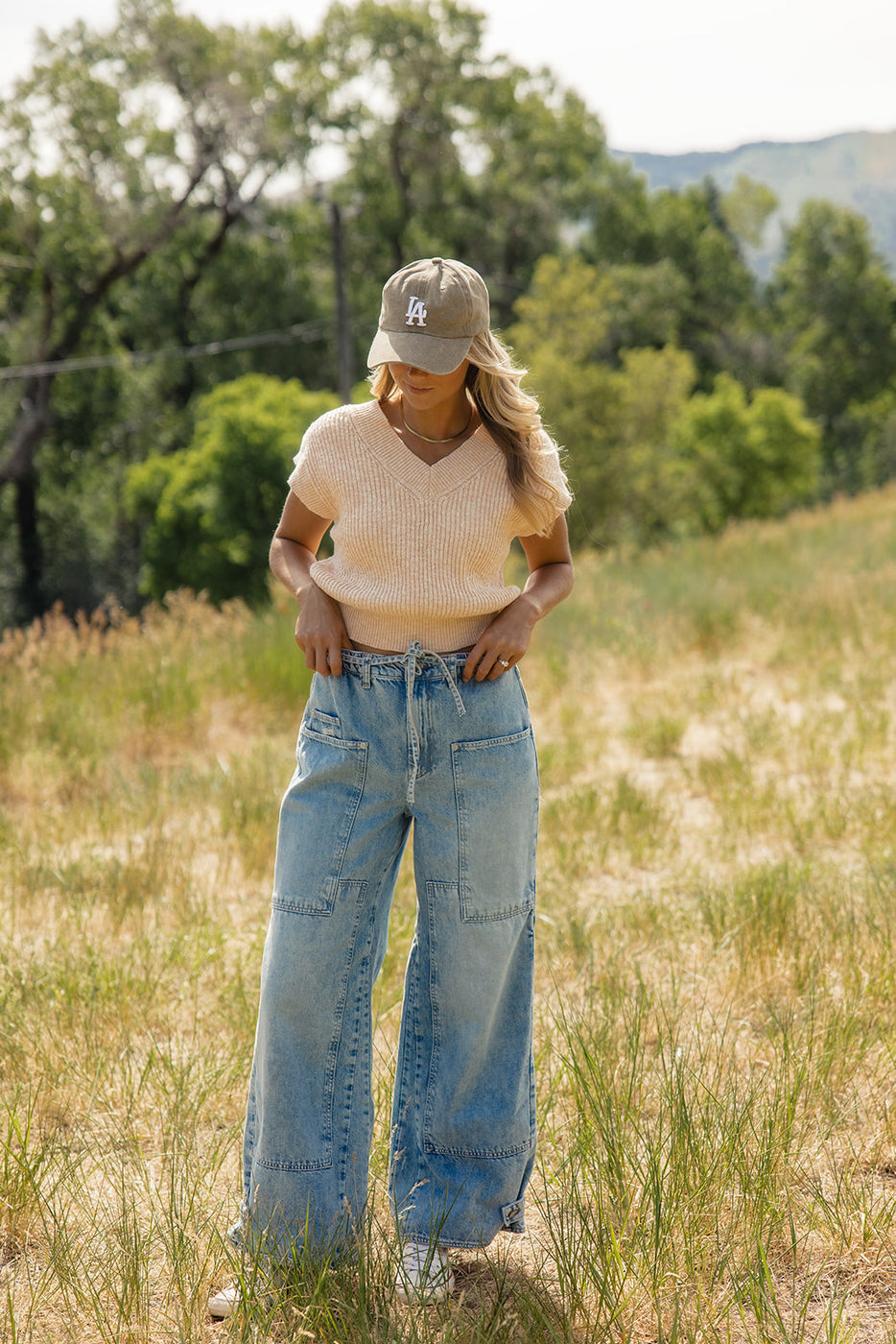 a woman in a hat and jeans