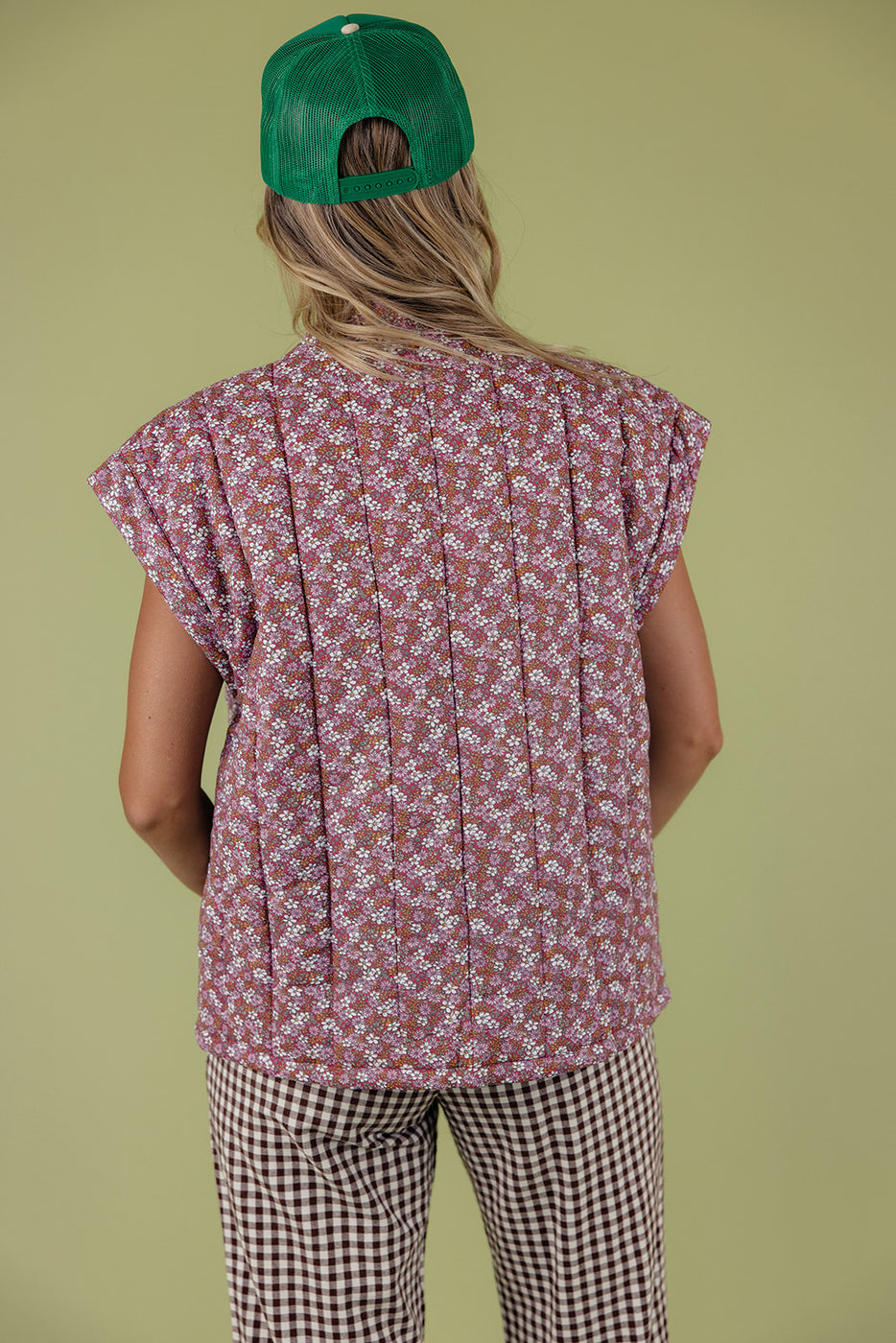 a woman wearing a floral shirt