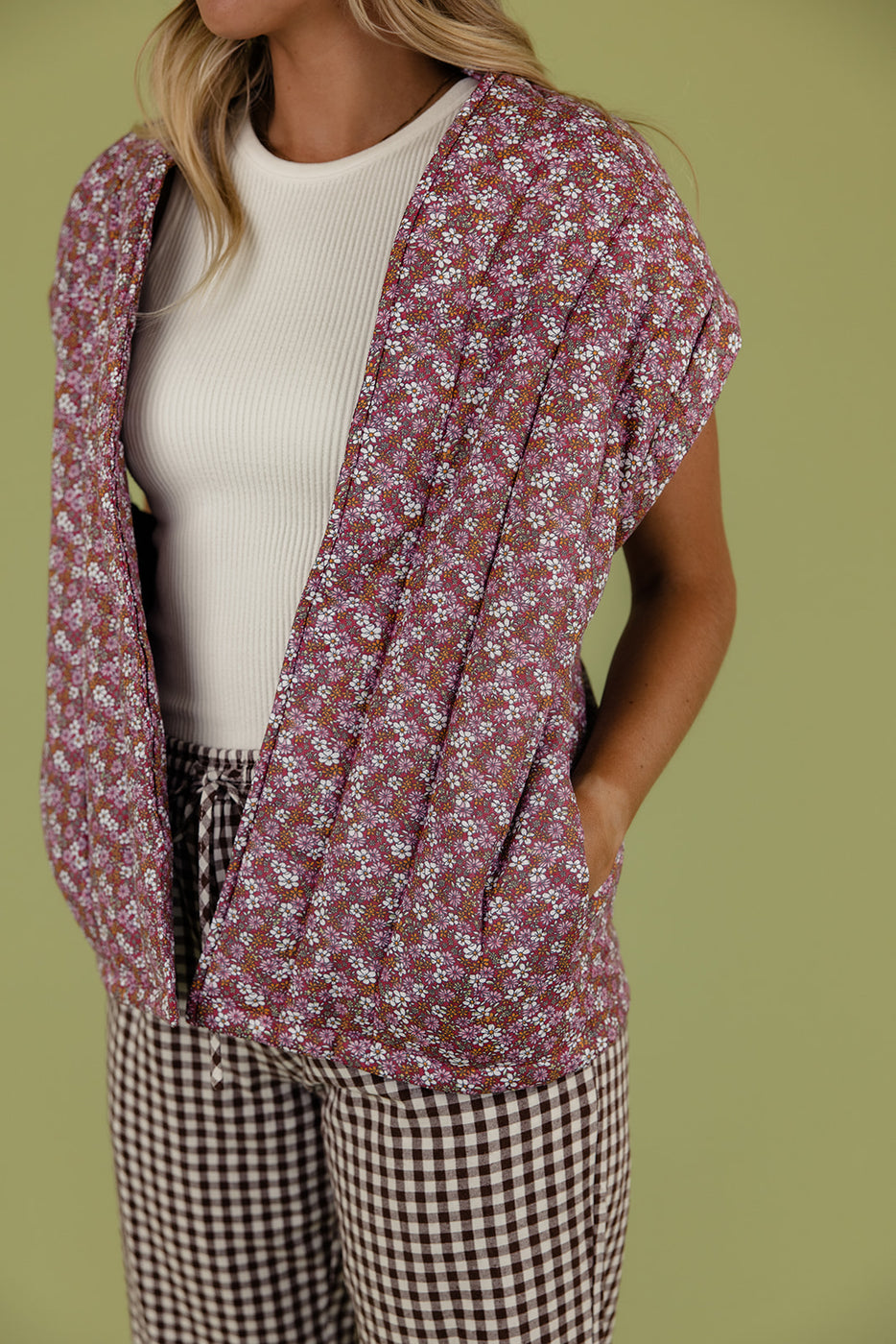 a woman wearing a floral vest