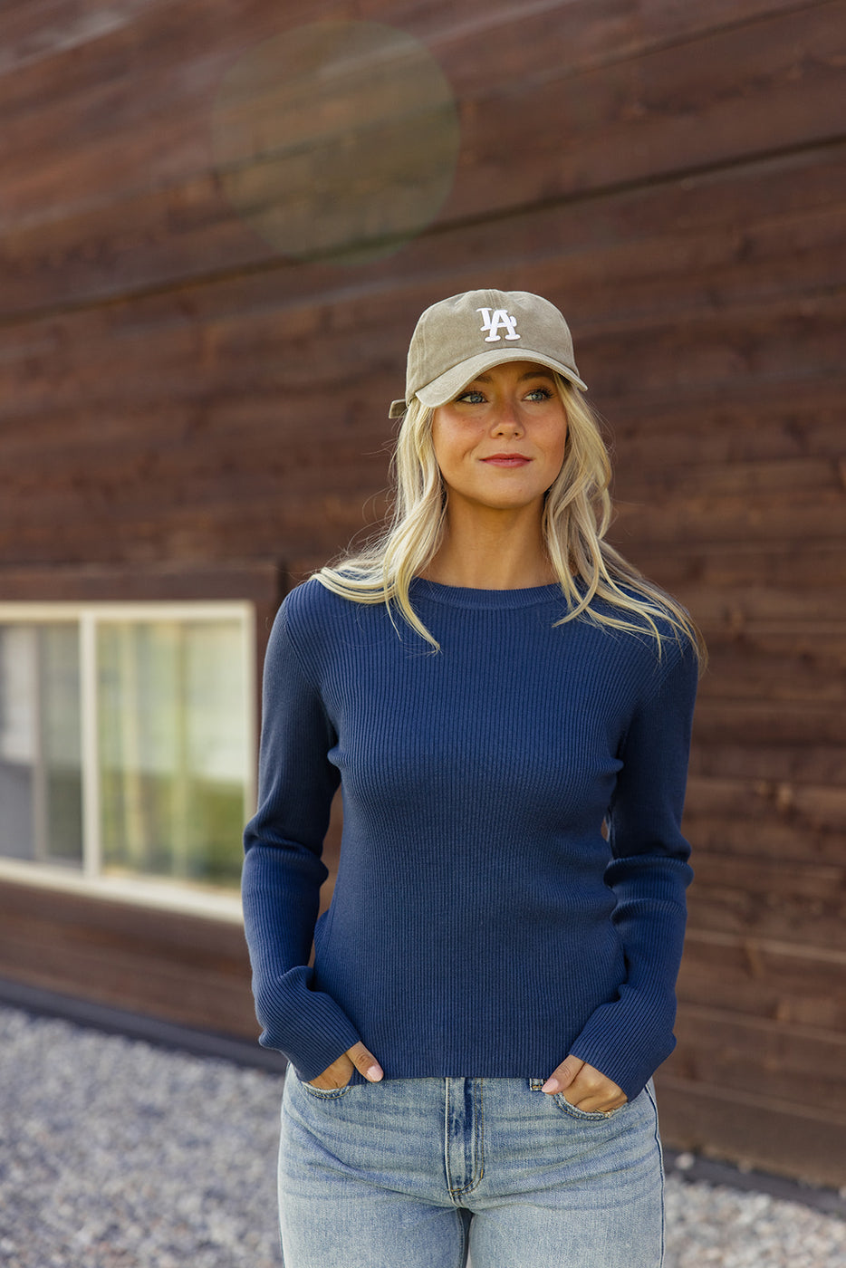 a woman in a blue sweater and hat