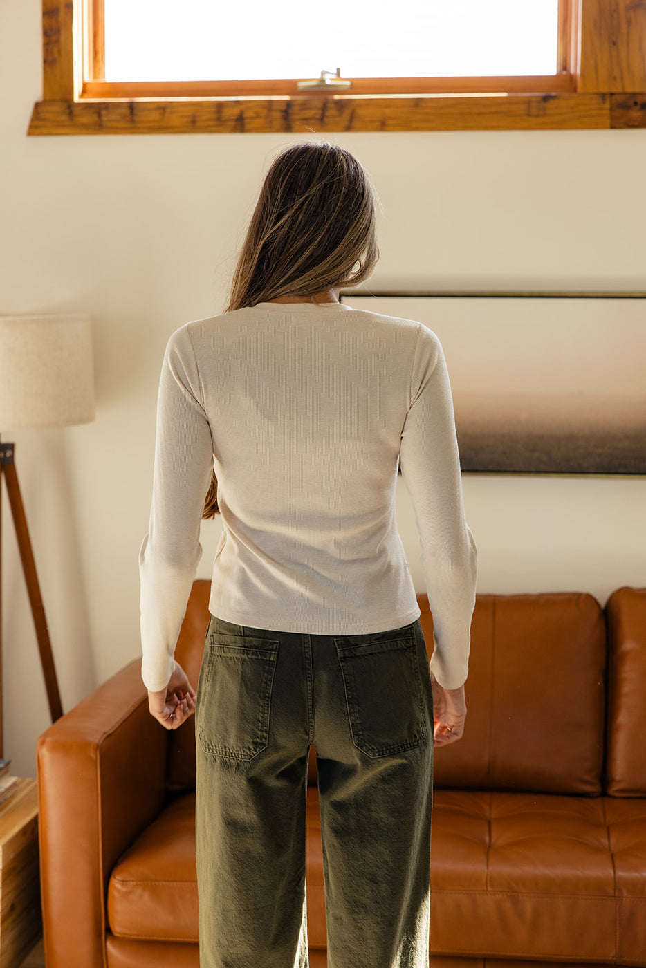 a woman standing in front of a couch