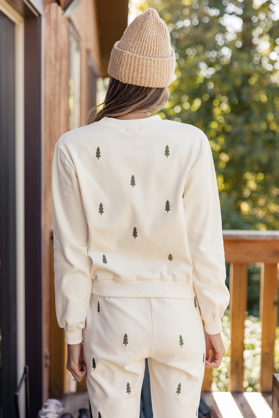 a woman wearing a white sweater and hat