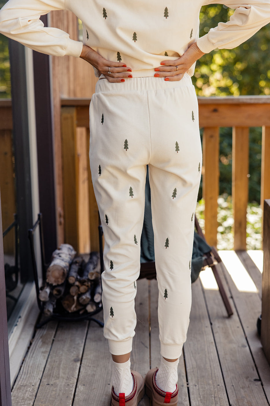 a person wearing white pants with trees on them