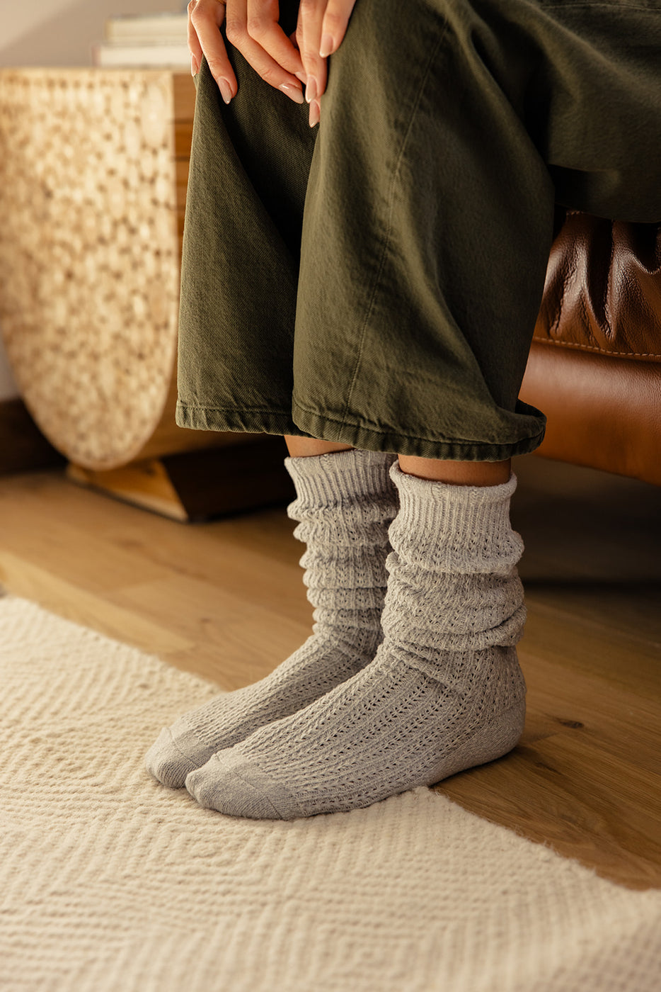 a person wearing socks and sitting on a couch