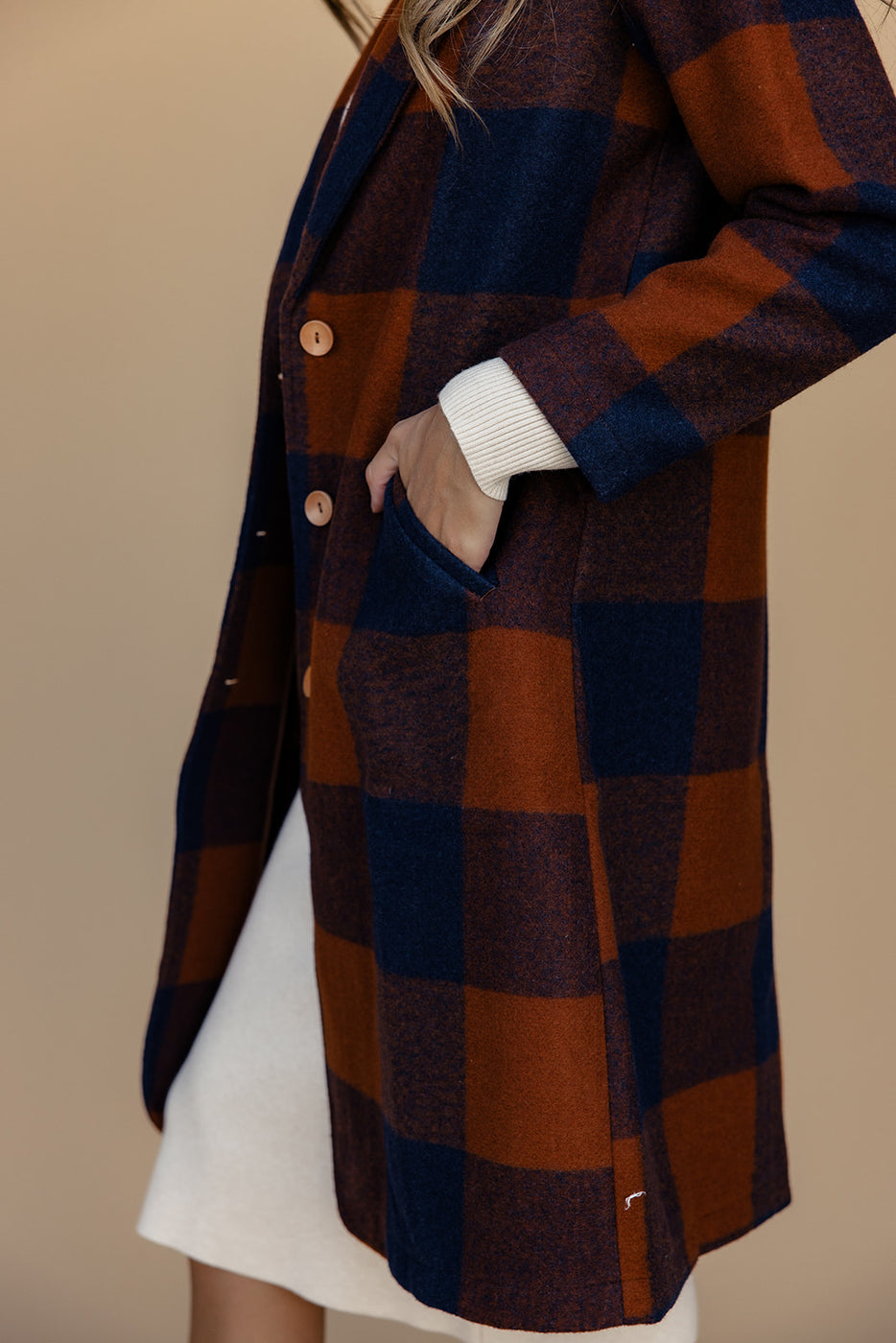 a person wearing a plaid coat