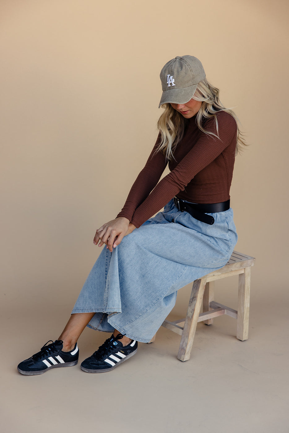 a woman sitting on a stool