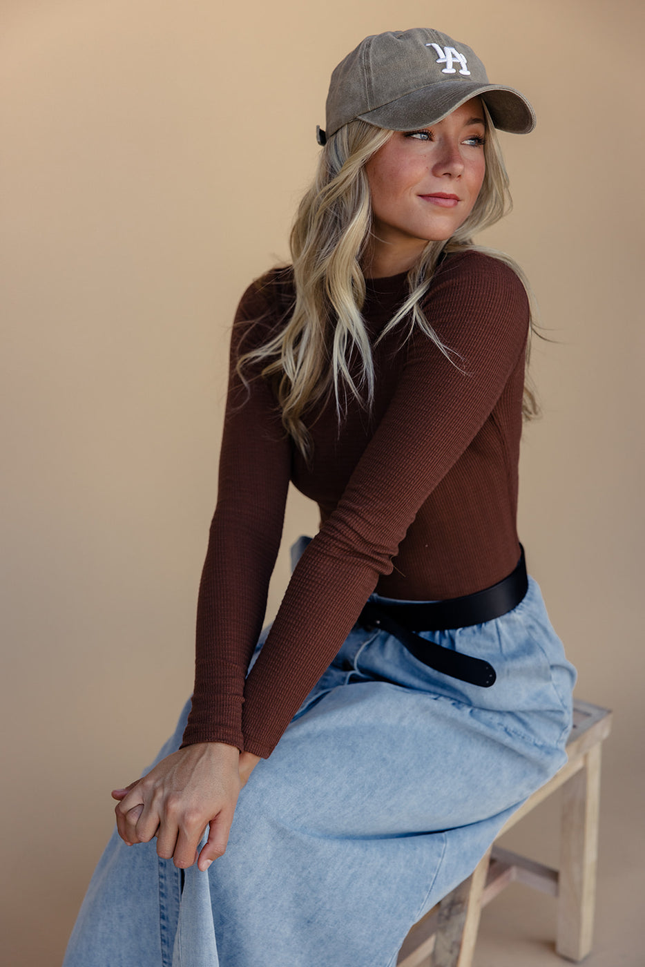 a woman sitting on a stool