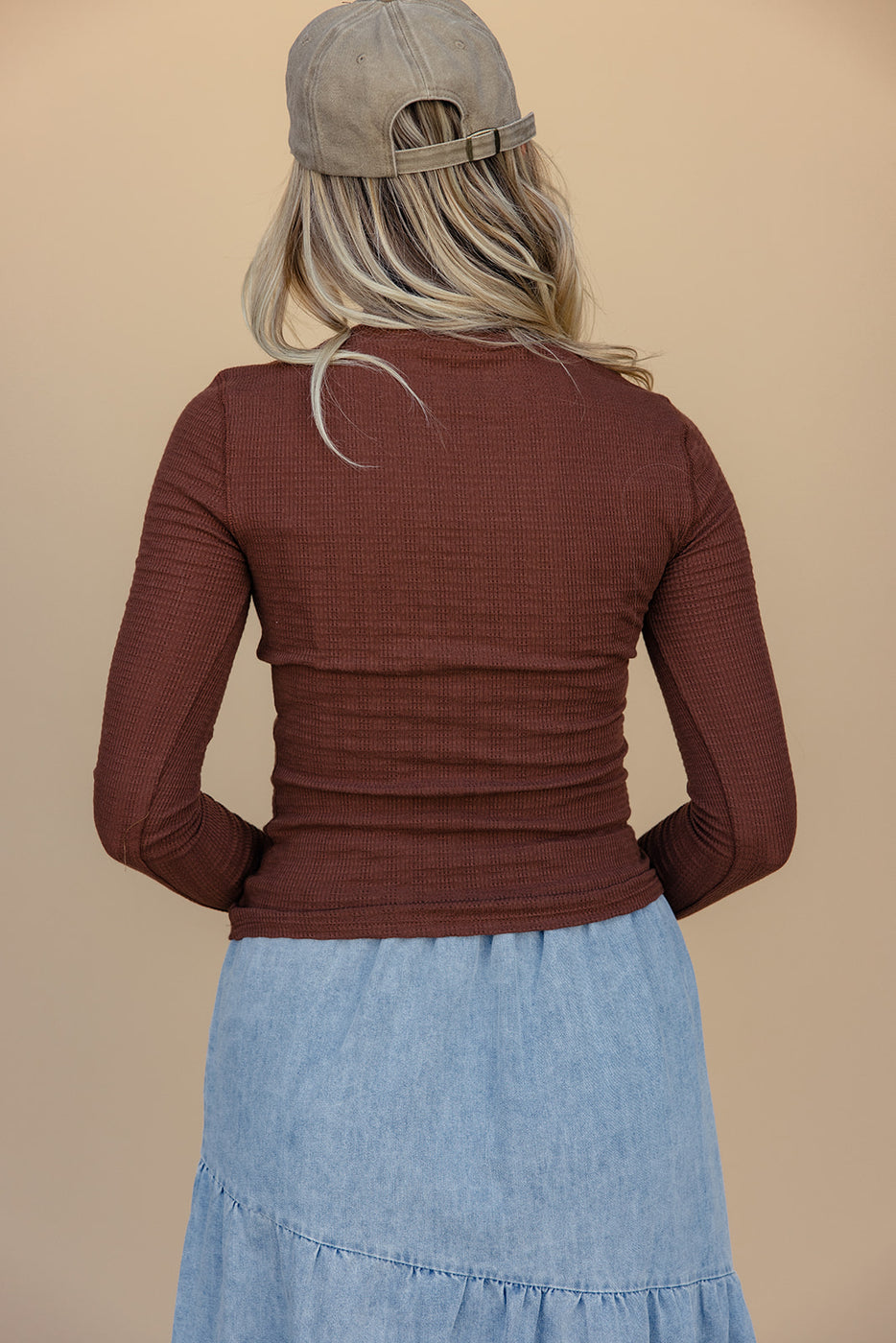 a woman in a brown sweater