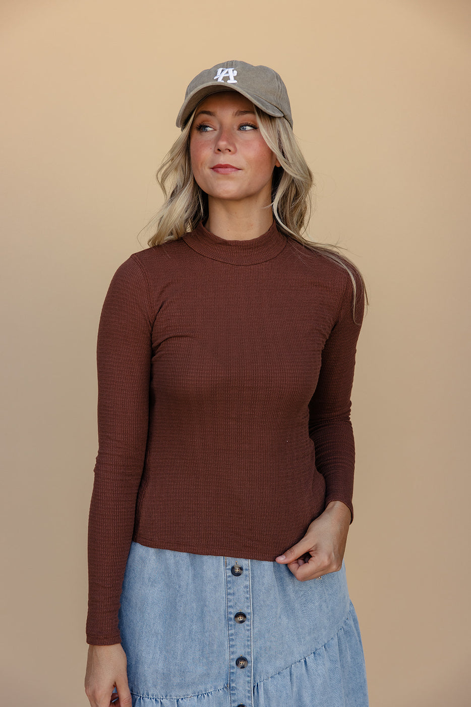 a woman in a brown sweater