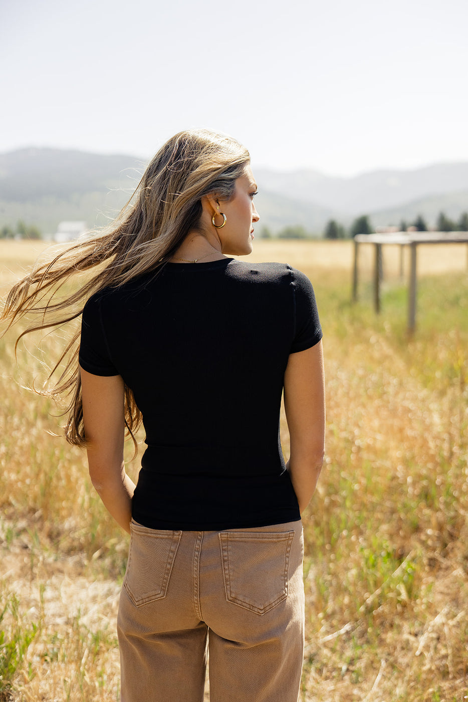 a woman standing in a field