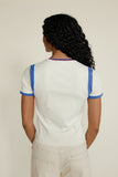 Woman wearing a blue and white tee against a white background