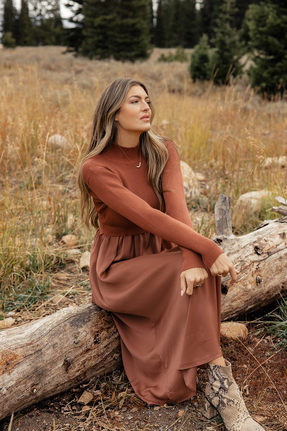 a woman sitting on a log