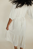 White dress worn by a person against a plain background