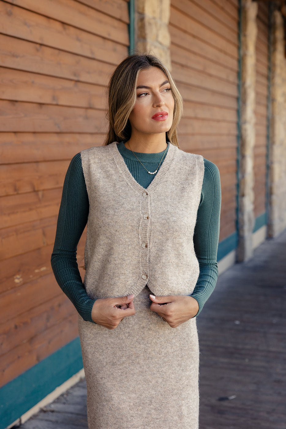 a woman in a sweater and vest