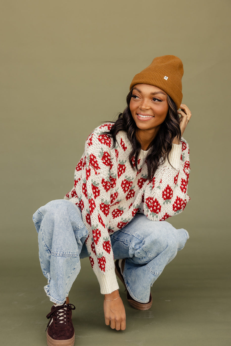 a woman squatting down and smiling