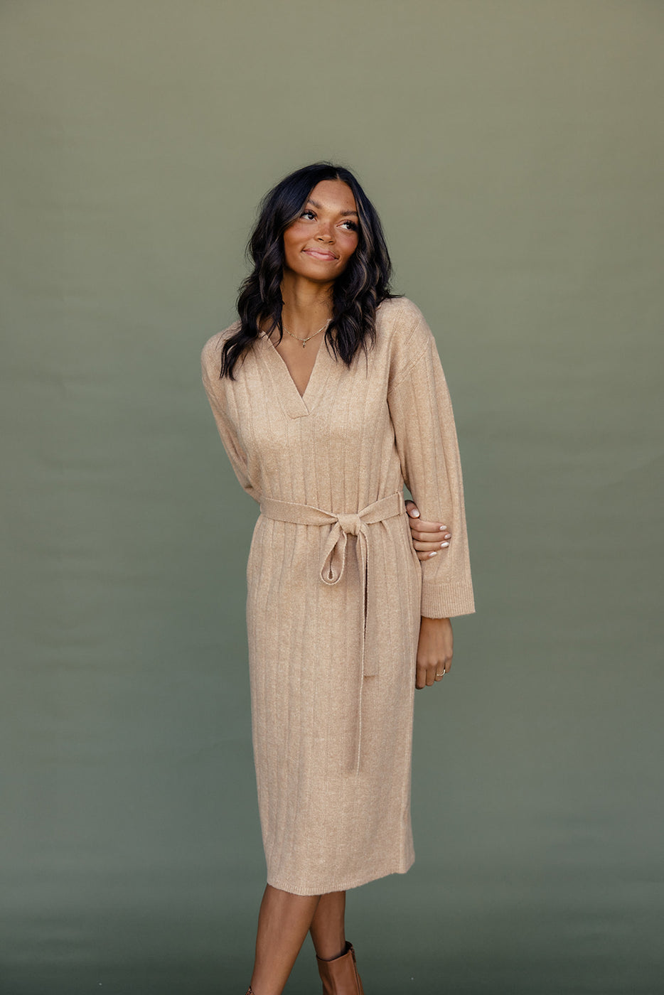 a woman in a beige dress