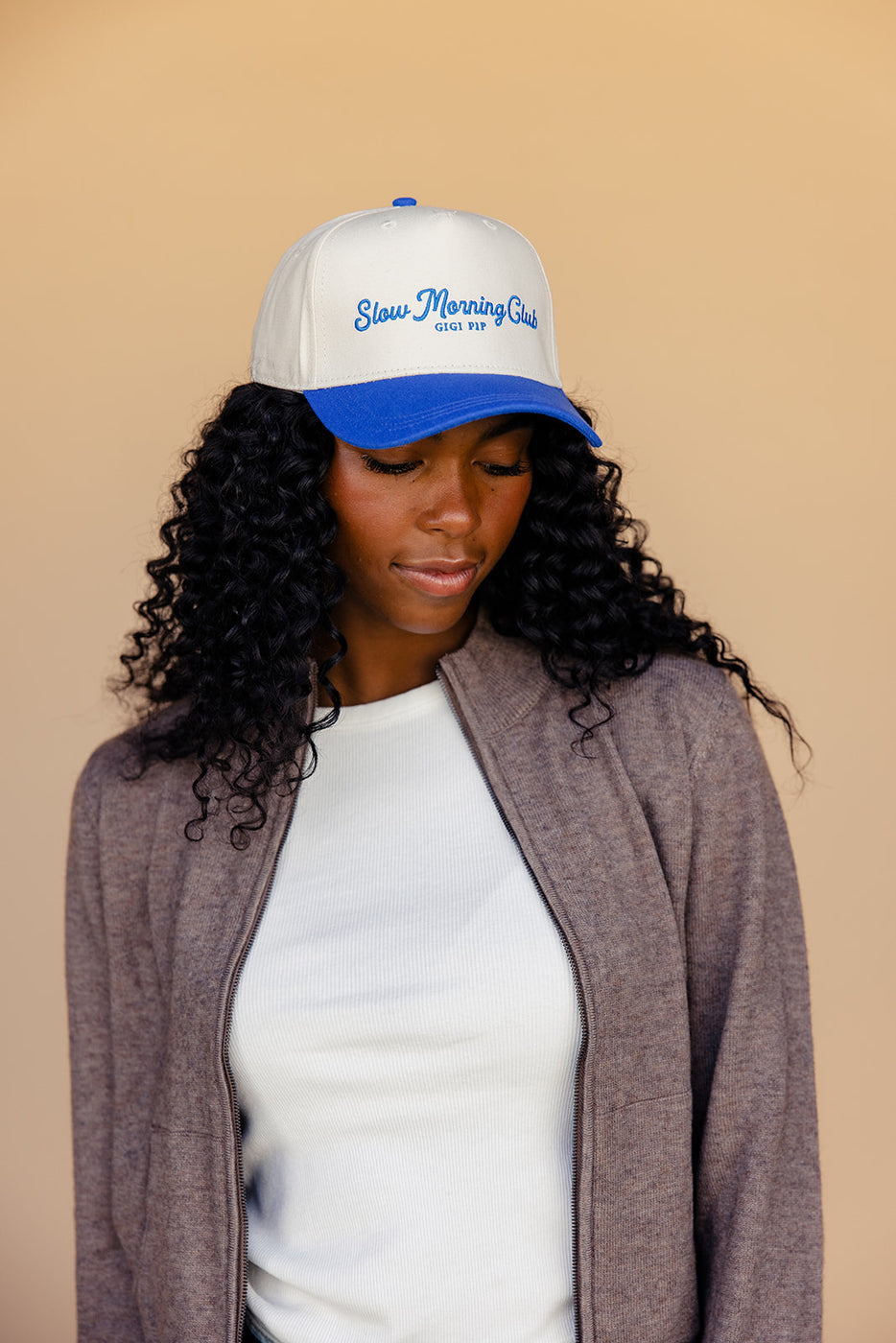 a woman wearing a white and blue hat