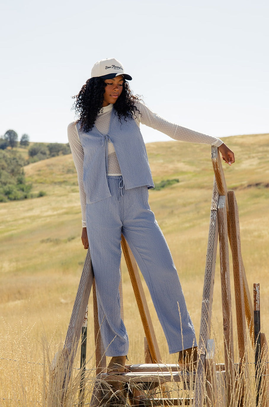 a woman leaning on a ladder