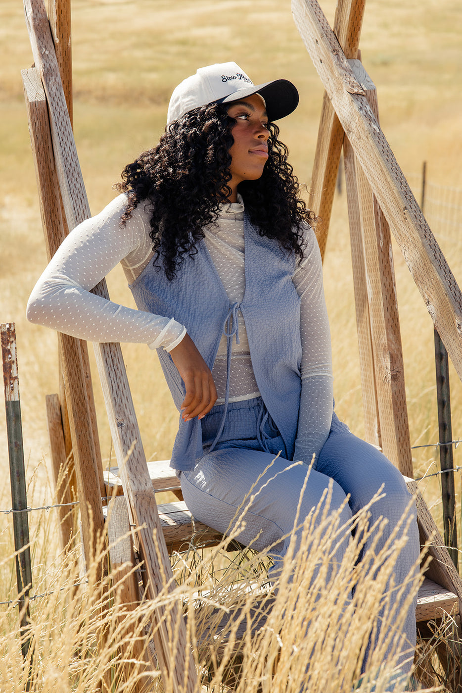 a woman sitting on a wooden structure