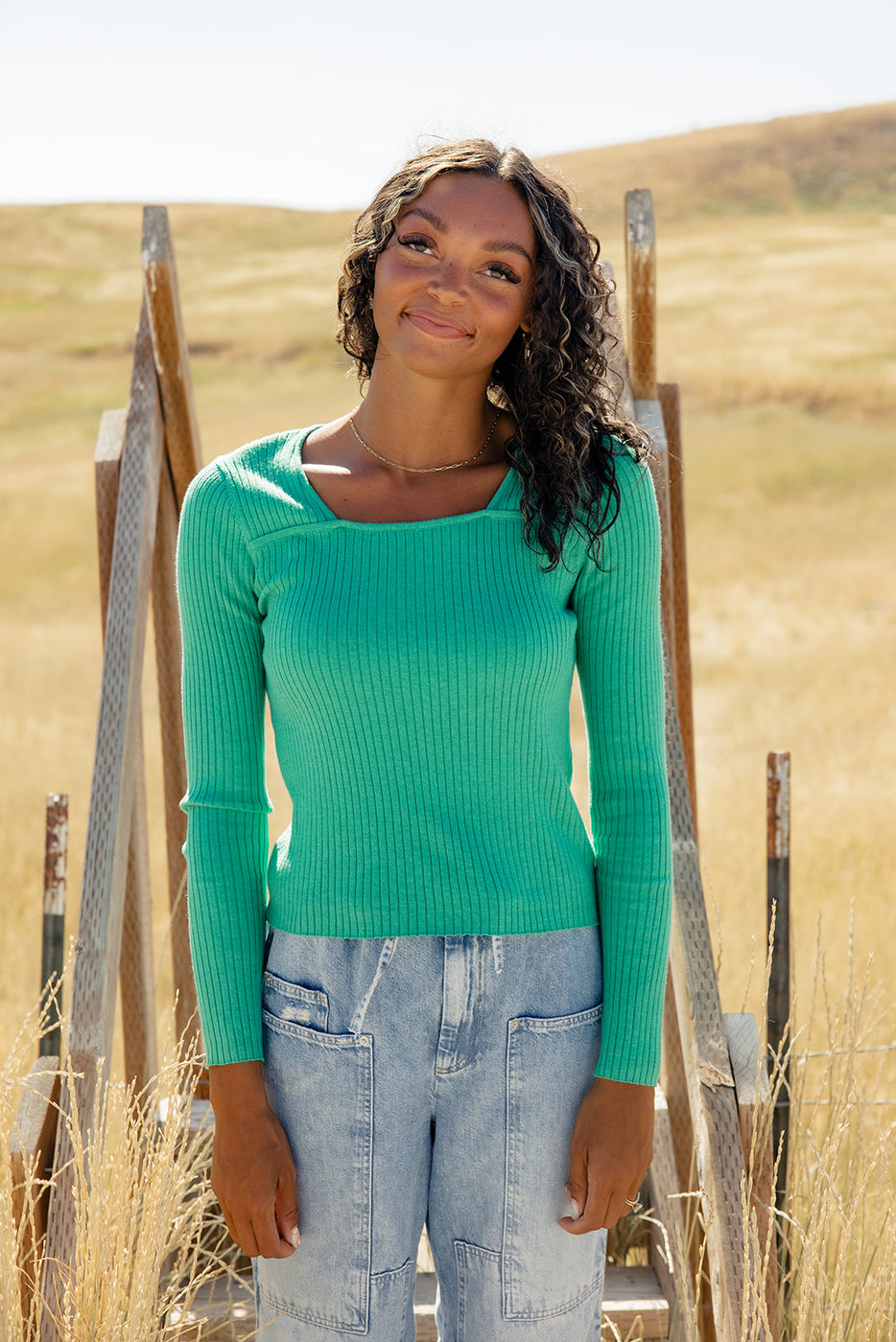 a woman in a green sweater