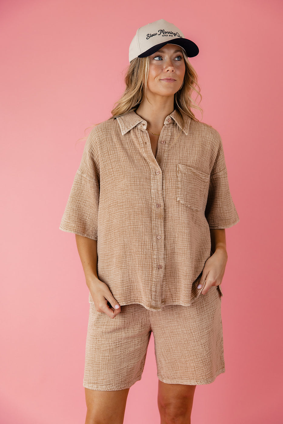 a woman in a beige shirt and pants