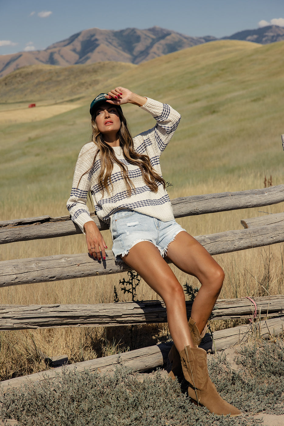 a woman sitting on a fence