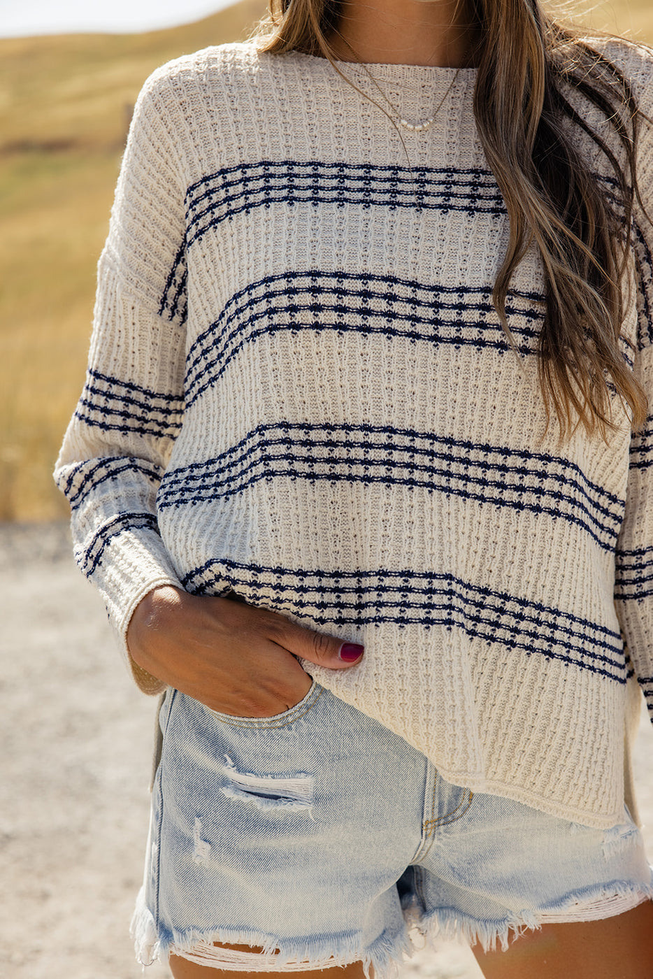 a woman wearing a sweater and jeans