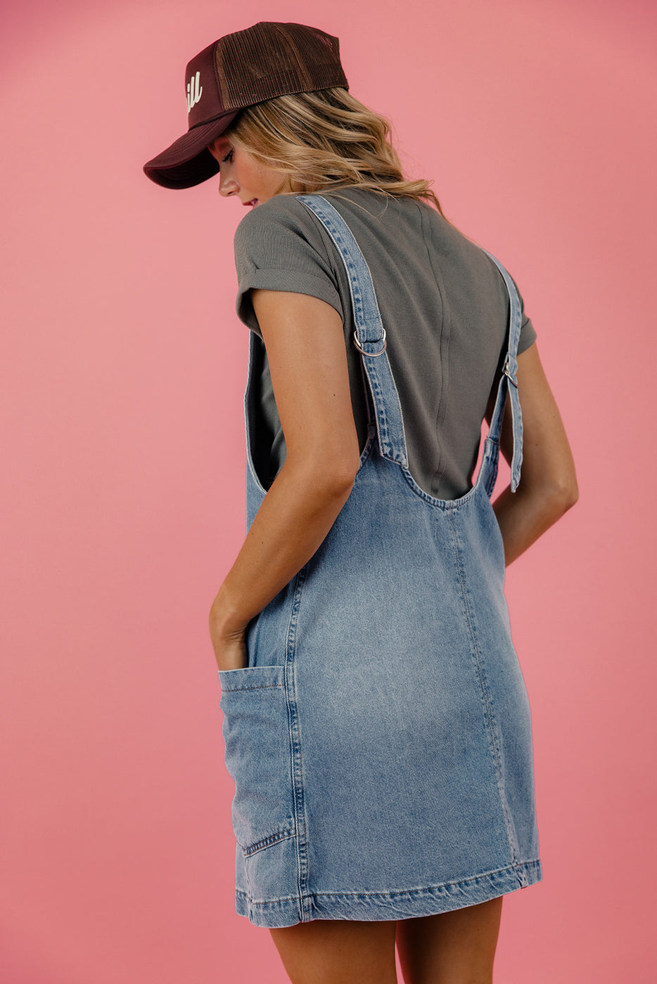 a woman in a denim overalls