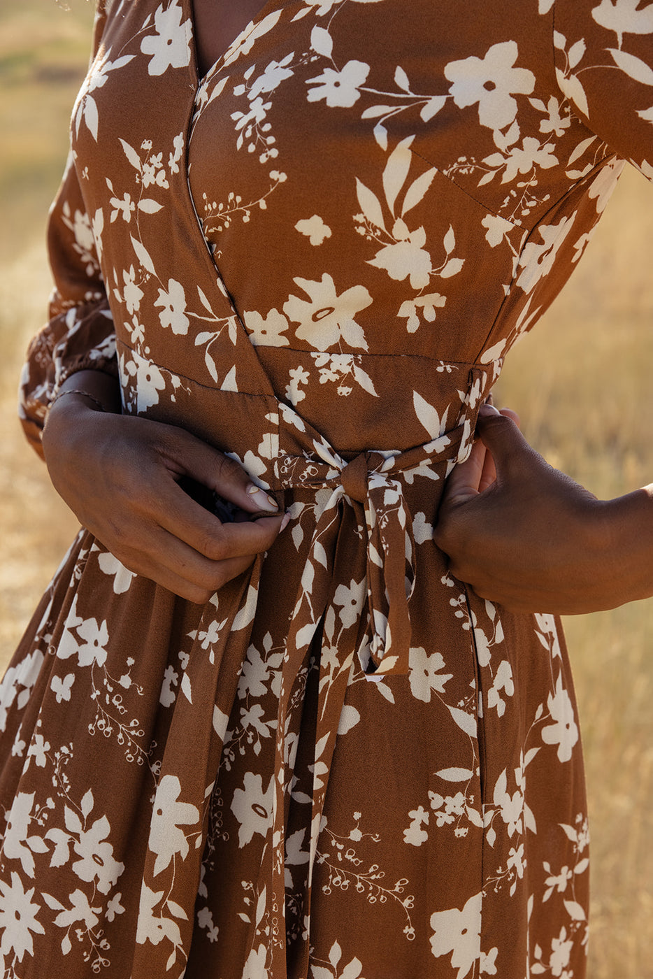 a woman wearing a brown dress