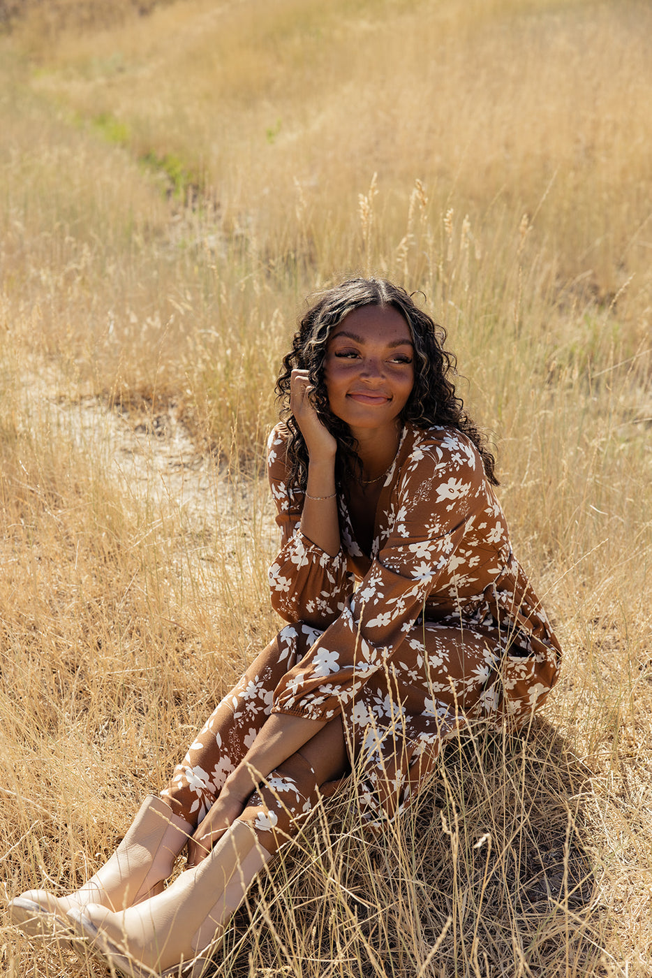 a woman sitting in a field