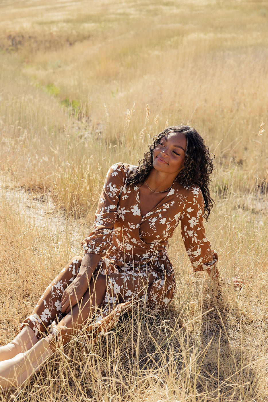 a woman sitting in a field