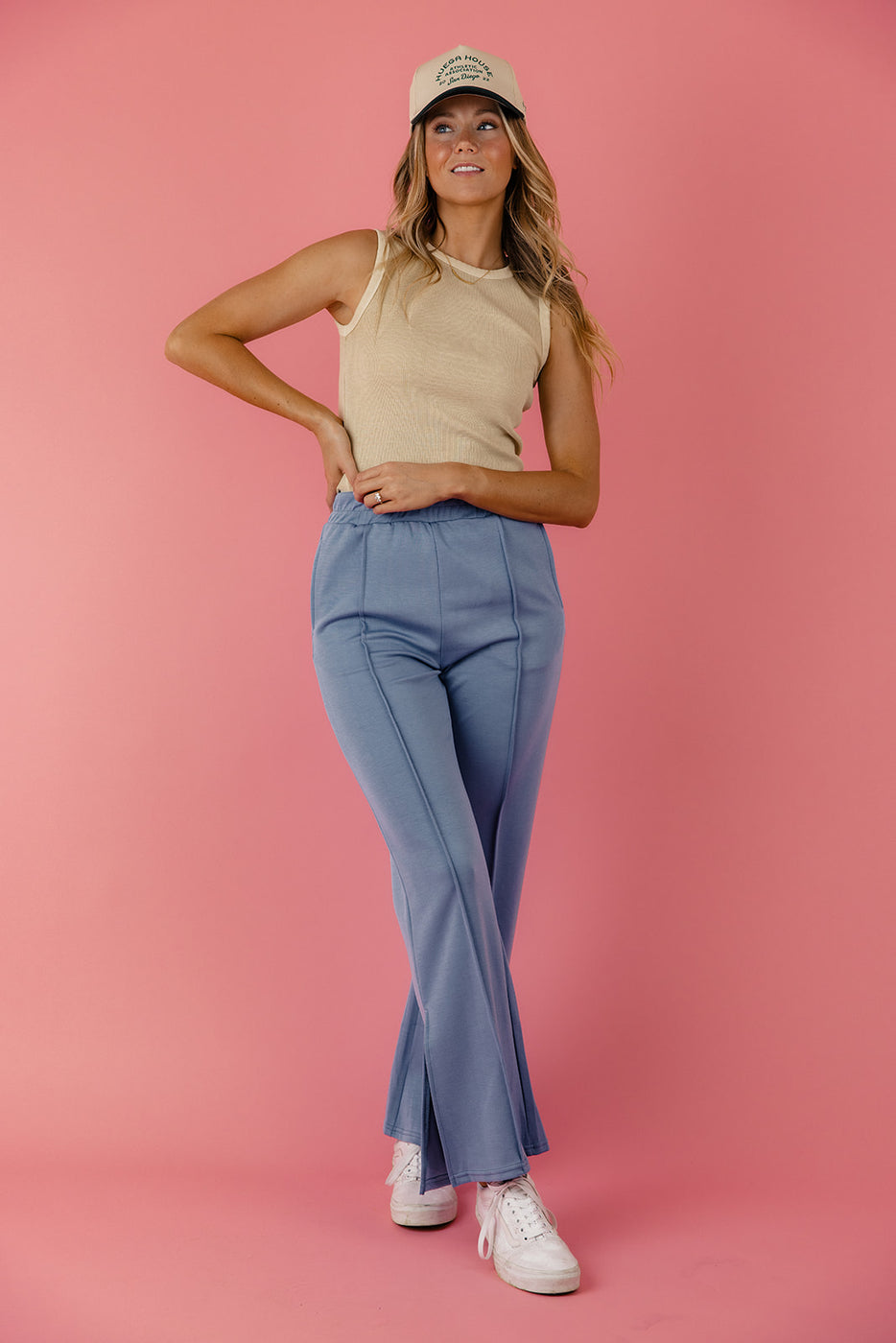 a woman in a blue pants and a tan shirt