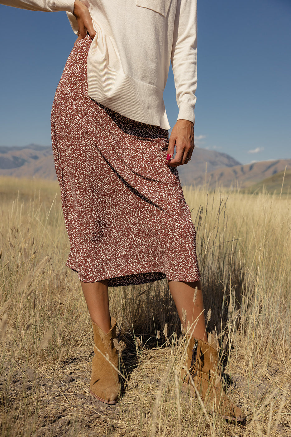 a woman wearing a skirt and boots