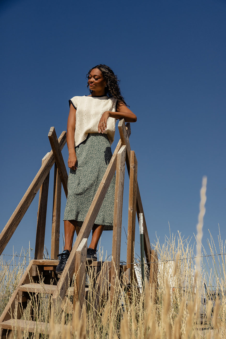 a woman standing on a wooden ladder