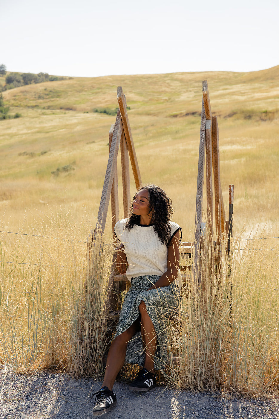 a woman sitting in a chair in a field