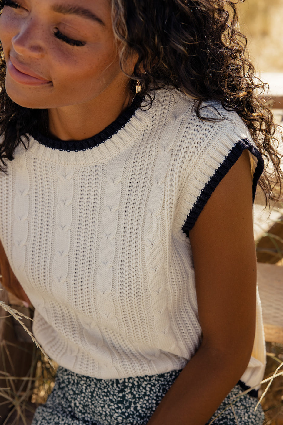 a woman wearing a white sweater