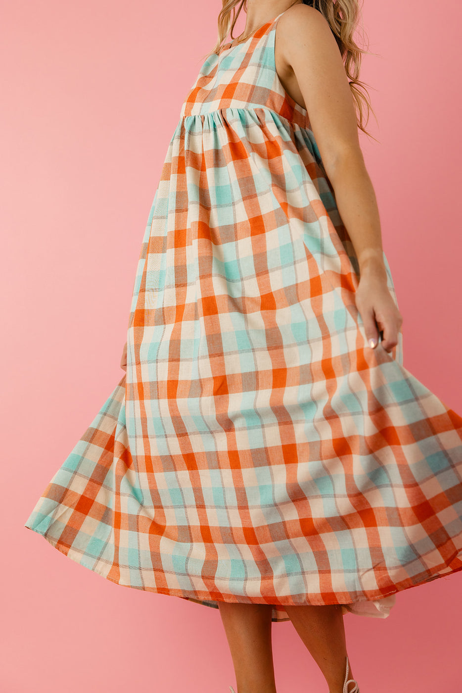 a woman wearing a plaid dress