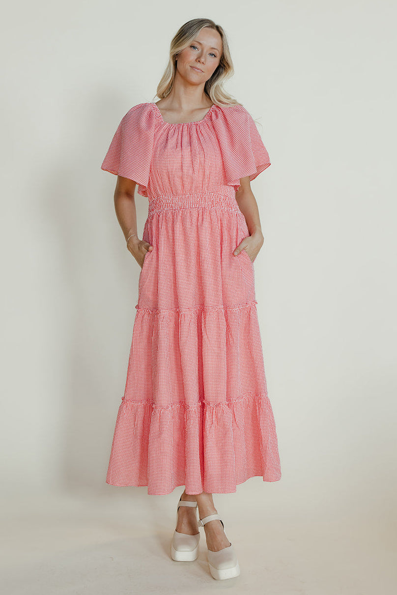 Woman wearing a pink dress against a white background