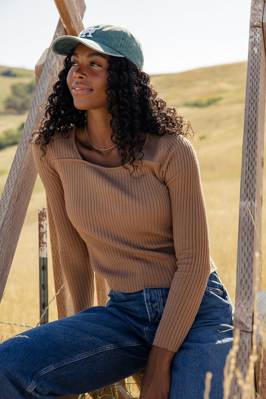 a woman sitting on a wooden structure