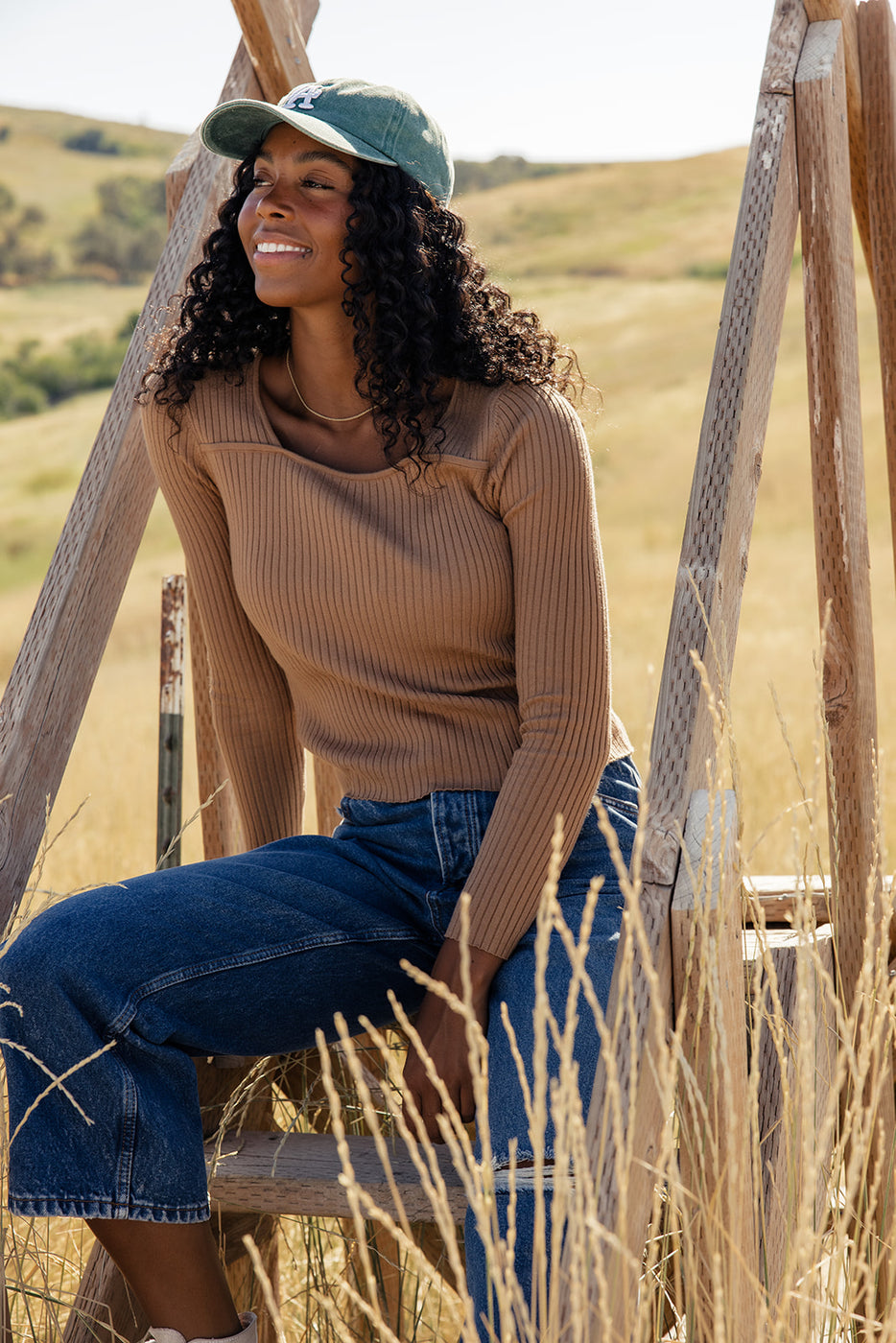 a woman sitting on a wooden structure