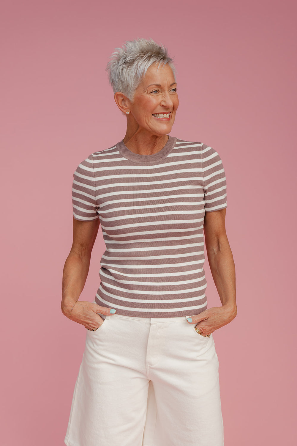 Woman wearing a striped tee and white shorts